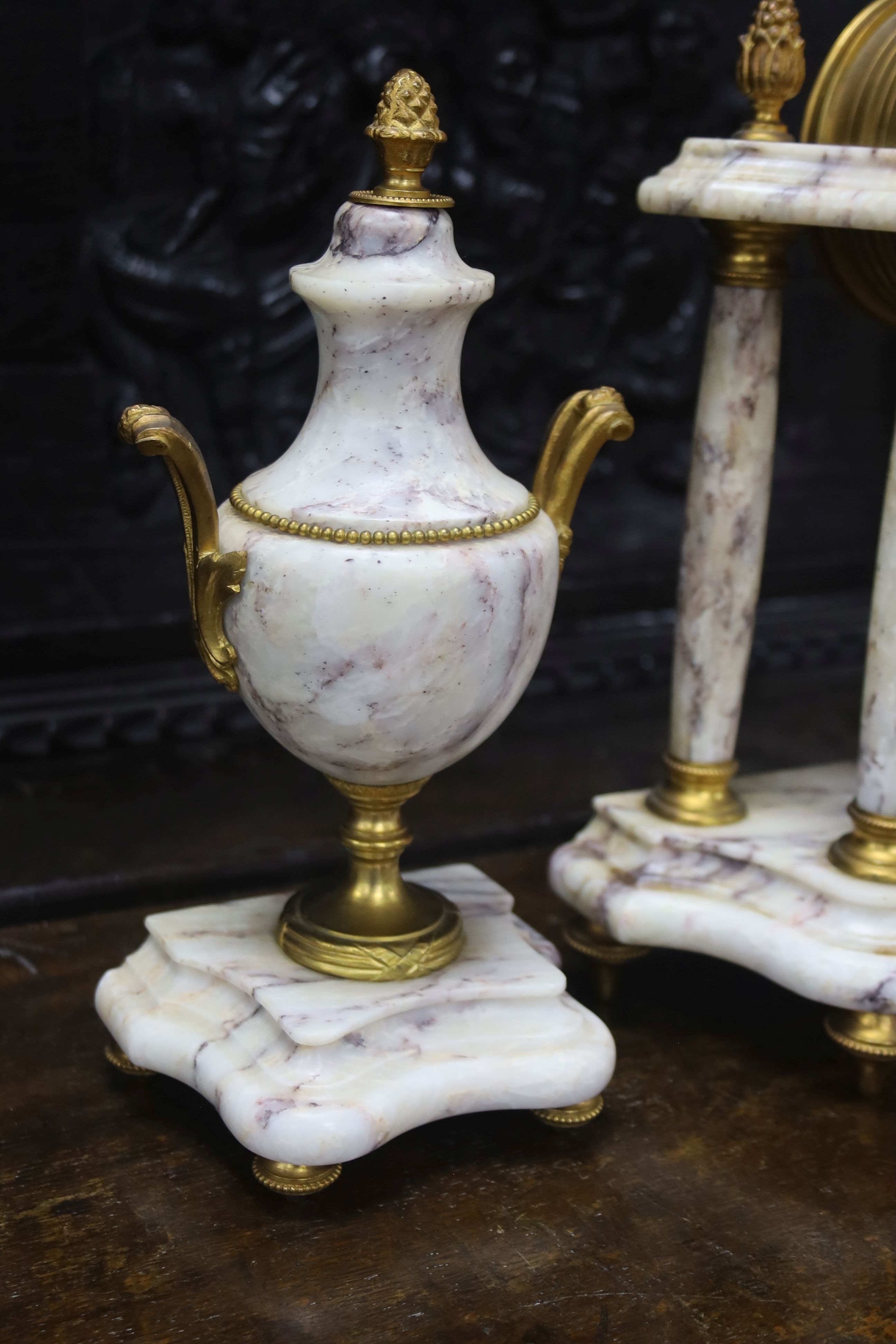 A late 19th century French three piece clock set, in Louis XVI taste with key and pendulum 42cm